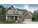 Beautiful two-story home with a brick and gray facade, complemented by a well-manicured lawn and lush green trees at 5378 Pelion Pl, McCordsville, IN 46055
