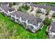 Aerial view of townhomes with screened porches, lush landscaping and mature trees at 5453 Nighthawk Way, Indianapolis, IN 46254