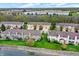 Aerial view of townhouses in a waterfront community with lush green spaces at 5453 Nighthawk Way, Indianapolis, IN 46254