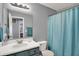Bathroom featuring neutral walls, a vanity sink, and a shower with blue curtain at 5453 Nighthawk Way, Indianapolis, IN 46254