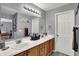 Bathroom with double sink vanity, modern lighting, and neutral decor at 5453 Nighthawk Way, Indianapolis, IN 46254