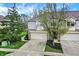 Well-maintained townhouse featuring an attached garage and tidy front lawn at 5453 Nighthawk Way, Indianapolis, IN 46254