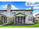 Rear exterior showing a screened porch and manicured lawn with landscaping at 5453 Nighthawk Way, Indianapolis, IN 46254
