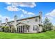 Backyard view of home with a screened porch and well-maintained landscaping at 5453 Nighthawk Way, Indianapolis, IN 46254