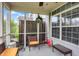 Relaxing screened porch featuring comfortable wicker furniture and bright natural light at 5453 Nighthawk Way, Indianapolis, IN 46254