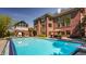 Exterior of home with a spacious pool, outdoor seating, and lush landscaping, perfect for entertaining at 553 Bolderwood Ln, Carmel, IN 46032