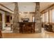 Charming home bar area with stone pillars and seating for entertaining at 553 Bolderwood Ln, Carmel, IN 46032