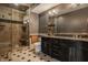 Elegant bathroom with a glass shower, dark wood vanity, and sleek black countertop at 553 Bolderwood Ln, Carmel, IN 46032