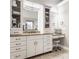 Bathroom vanity featuring granite countertops, ample storage, a makeup vanity, and stylish mirrors at 553 Bolderwood Ln, Carmel, IN 46032