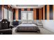 Bedroom featuring striped walls, two windows, a flat panel TV, a comfortable bed, and dark furnishings at 553 Bolderwood Ln, Carmel, IN 46032