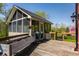 Outdoor deck with a screened-in structure, greenery, wooden deck and an Egg grill at 553 Bolderwood Ln, Carmel, IN 46032