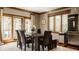 Elegant dining room with large windows, modern decor, and seating for six at 553 Bolderwood Ln, Carmel, IN 46032