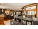 Open floor plan dining room with contemporary furnishings and a view into the kitchen at 553 Bolderwood Ln, Carmel, IN 46032