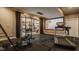 Home fitness center features a treadmill, rowing machine, and media capabilities at 553 Bolderwood Ln, Carmel, IN 46032