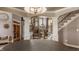 Elegant entryway featuring hardwood floors, staircase with iron spindles, and an archway to the living room at 553 Bolderwood Ln, Carmel, IN 46032