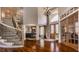 Spacious foyer with hardwood floors, a staircase, a chandelier, and transom window at 553 Bolderwood Ln, Carmel, IN 46032