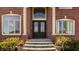 Elegant front entrance with double doors, sidelights, transom window, and brick facade at 553 Bolderwood Ln, Carmel, IN 46032