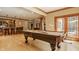 Beautiful game room with pool table, bar and seating area adjacent to a kitchen at 553 Bolderwood Ln, Carmel, IN 46032
