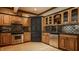 Basement kitchen featuring black and wood cabinets, stainless steel appliances, and a tile backsplash at 553 Bolderwood Ln, Carmel, IN 46032