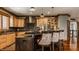 Kitchen island with seating and stainless steel appliances at 553 Bolderwood Ln, Carmel, IN 46032