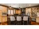 Stylish kitchen island featuring pendant lighting, breakfast bar seating, and sleek countertops at 553 Bolderwood Ln, Carmel, IN 46032