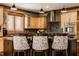 Kitchen island with seating and custom cabinetry at 553 Bolderwood Ln, Carmel, IN 46032