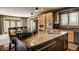 Kitchen island featuring granite countertops and modern appliances at 553 Bolderwood Ln, Carmel, IN 46032