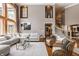 Bright living room with neutral decor, hardwood floors, large windows, and comfortable seating at 553 Bolderwood Ln, Carmel, IN 46032