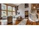 Bright living room featuring hardwood floors, high ceilings, and large windows at 553 Bolderwood Ln, Carmel, IN 46032