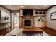 Stylish living room with fireplace, built-in cabinets, and hardwood floors at 553 Bolderwood Ln, Carmel, IN 46032