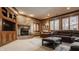 Cozy living room with a stone fireplace, comfortable seating, and a large window at 553 Bolderwood Ln, Carmel, IN 46032
