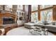 Cozy living room showcasing stone fireplace, built-ins, and plenty of natural light at 553 Bolderwood Ln, Carmel, IN 46032
