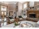 Spacious living room boasts high ceilings, hardwood floors, stone fireplace, and natural light at 553 Bolderwood Ln, Carmel, IN 46032