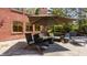 Outdoor patio featuring comfortable seating under a large umbrella next to the home and pool at 553 Bolderwood Ln, Carmel, IN 46032