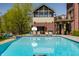 Swimming pool featuring lounge seating, half basketball court, and connected covered porch at 553 Bolderwood Ln, Carmel, IN 46032