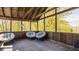 Inviting screened-in porch with comfortable seating and a serene view of the surrounding landscape at 553 Bolderwood Ln, Carmel, IN 46032