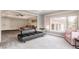 Sitting area with large windows, a plush pink chair, and access to the main bedroom with a ceiling fan at 553 Bolderwood Ln, Carmel, IN 46032