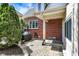 Backyard brick patio featuring a grill, lush landscaping, and a well maintained brick exterior at 5611 N Delaware St, Indianapolis, IN 46220