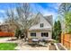 A cozy backyard features a brick patio with an outdoor dining set and well-manicured landscaping at 5611 N Delaware St, Indianapolis, IN 46220