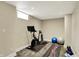 Basement featuring an exercise bike, yoga ball, yoga mat, and tiled floor at 5611 N Delaware St, Indianapolis, IN 46220