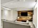 Finished basement featuring a gray couch, wooden coffee table, wood paneling, and gray tiled floors at 5611 N Delaware St, Indianapolis, IN 46220