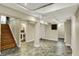 Finished basement with stairs, tiled floor, and white walls and trim at 5611 N Delaware St, Indianapolis, IN 46220