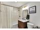 Well-lit bathroom features a shower and tub combination, modern vanity with beautiful fixtures at 5611 N Delaware St, Indianapolis, IN 46220