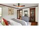 Comfortable bedroom with a ceiling fan, neutral paint colors, hardwood floors and lots of natural light at 5611 N Delaware St, Indianapolis, IN 46220