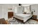 Well-lit bedroom featuring hardwood floors, stylish decor, and windows that provide lots of natural light at 5611 N Delaware St, Indianapolis, IN 46220
