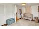 Bedroom with crib, wood floors, a light blue toy chest, and white trim and walls at 5611 N Delaware St, Indianapolis, IN 46220