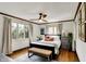 Cozy bedroom featuring stylish decor, windows that provide lots of natural light, and hardwood floors at 5611 N Delaware St, Indianapolis, IN 46220