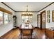 Bright dining area with hardwood floors, wooden table, and large windows offering natural light at 5611 N Delaware St, Indianapolis, IN 46220