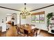 Well-lit dining room with a wooden table and chandelier, showcasing a cozy and inviting atmosphere at 5611 N Delaware St, Indianapolis, IN 46220