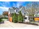 Beautiful house exterior with brick and siding, a well maintained lawn, and blossoming trees at 5611 N Delaware St, Indianapolis, IN 46220